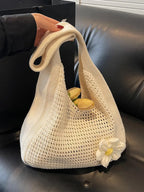 Women's solid-color straw bag with floral accents