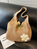 Women's solid-color straw bag with floral accents