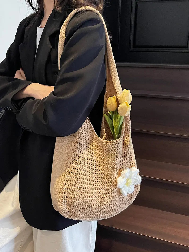 Women's solid-color straw bag with floral accents