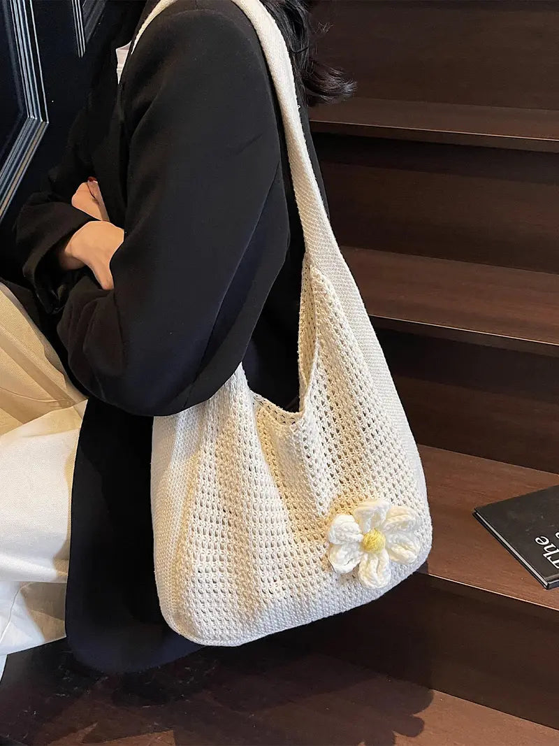 Women's solid-color straw bag with floral accents